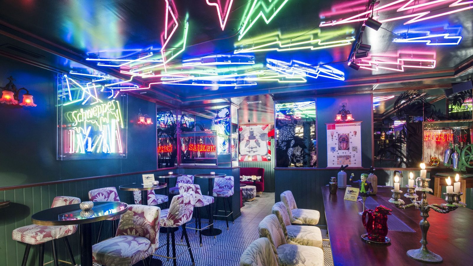 the neon-lit interior and mural at Salmón Guru on Calle de Echegaray